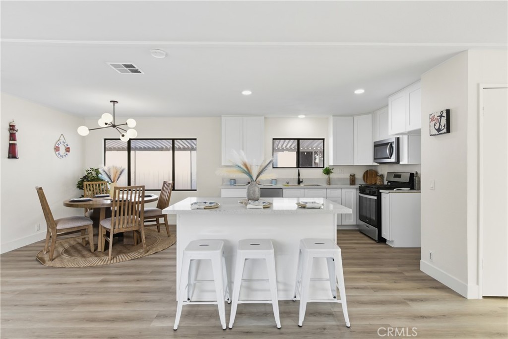 300 North Rampart Street, Unit 152 Orange, CA 92868 - Photo 11 of 29 a view of a dining room with furniture and wooden floor