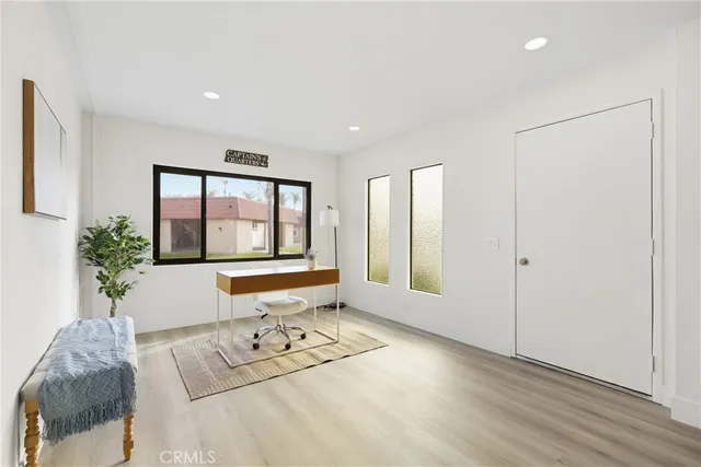 a living room with furniture and large windows