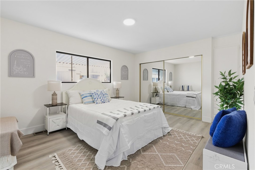 300 North Rampart Street, Unit 152 Orange, CA 92868 - Photo 15 of 29 a bedroom with a large bed and a couch