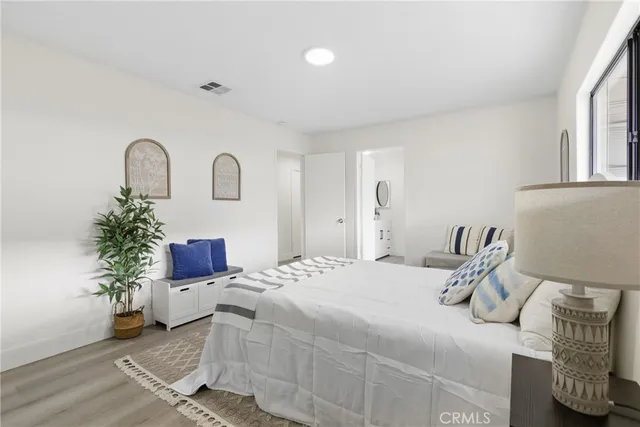a bedroom with a bed and a potted plant