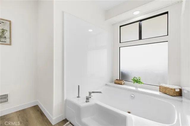 a bathroom with a tub and sink