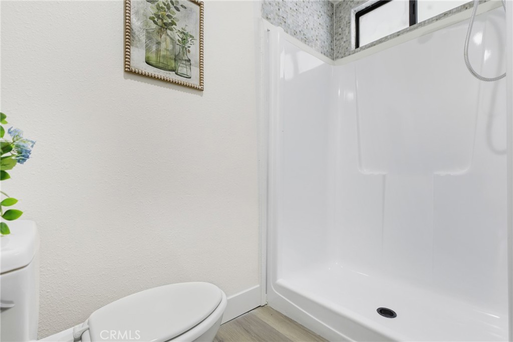 300 North Rampart Street, Unit 152 Orange, CA 92868 - Photo 21 of 29 a bathroom with a toilet and a shower