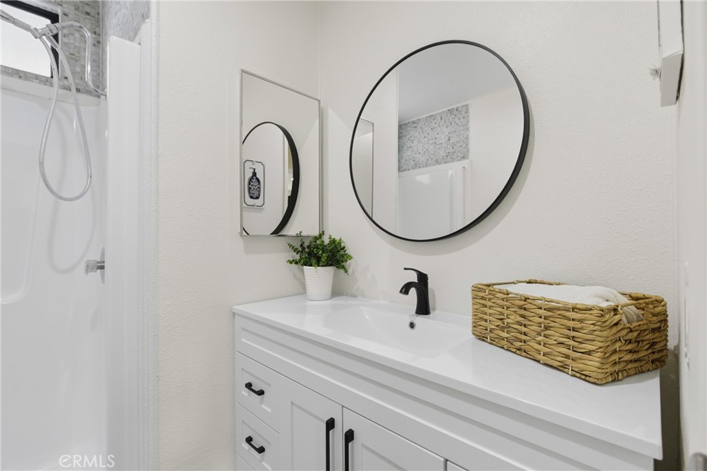 300 North Rampart Street, Unit 152 Orange, CA 92868 - Photo 22 of 29 a bathroom with a sink and a mirror