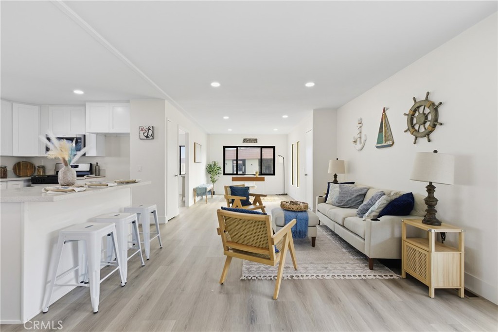 300 North Rampart Street, Unit 152 Orange, CA 92868 - Photo 4 of 29 a living room with furniture and a wooden floor