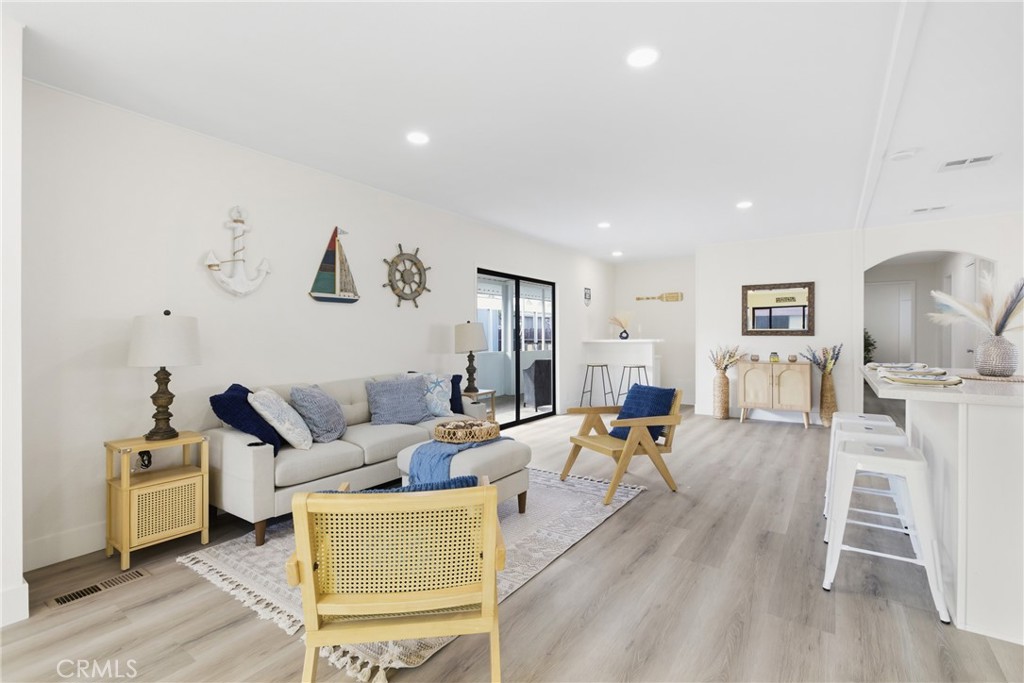 300 North Rampart Street, Unit 152 Orange, CA 92868 - Photo 5 of 29 a living room with furniture a wooden floor and white walls