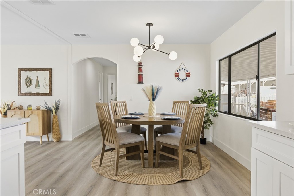 300 North Rampart Street, Unit 152 Orange, CA 92868 - Photo 7 of 29 a view of a dining room with furniture window and wooden floor