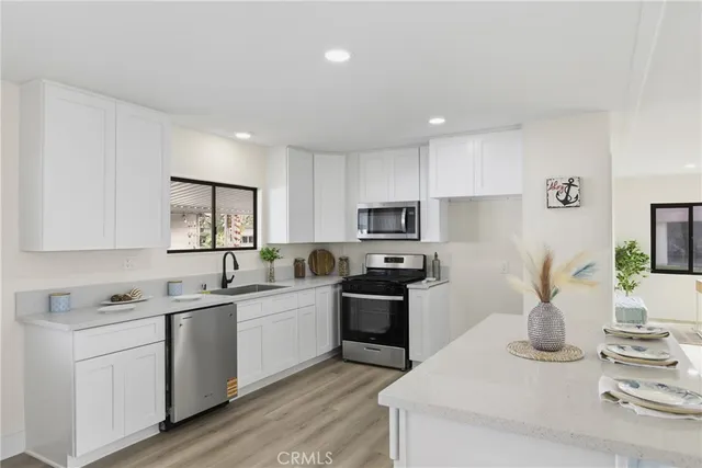 a kitchen with a sink stove and refrigerator