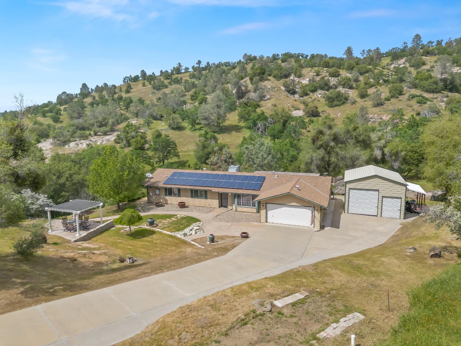 an aerial view of a house with a garden and lake view