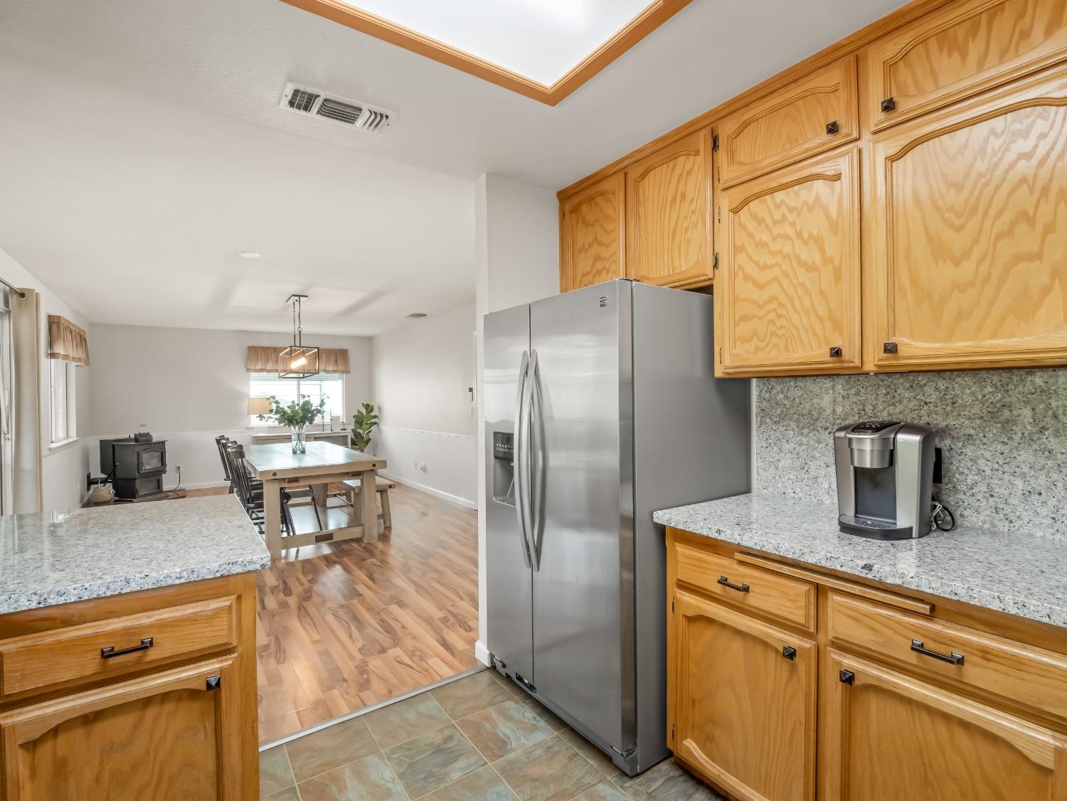 31173 Moccassin Way Coarsegold, CA 93614 - Photo 19 of 48 a kitchen with stainless steel appliances granite countertop a refrigerator and a stove top oven