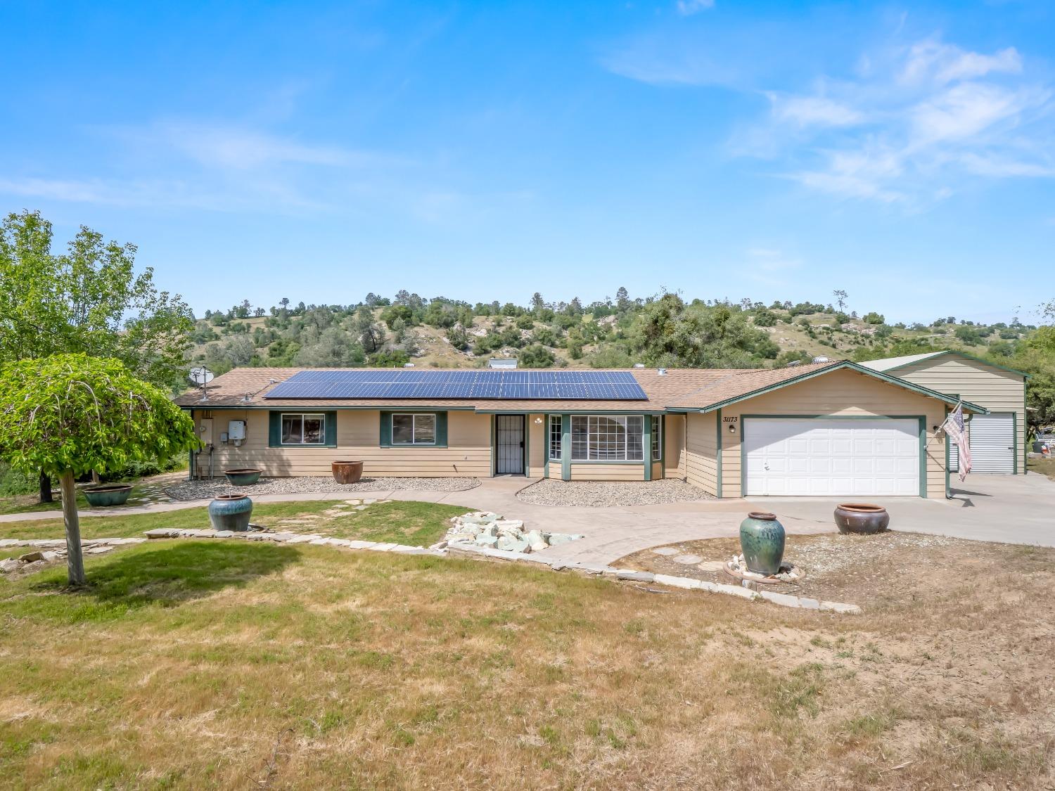 31173 Moccassin Way Coarsegold, CA 93614 - Photo 2 of 48 a front view of a house with a yard