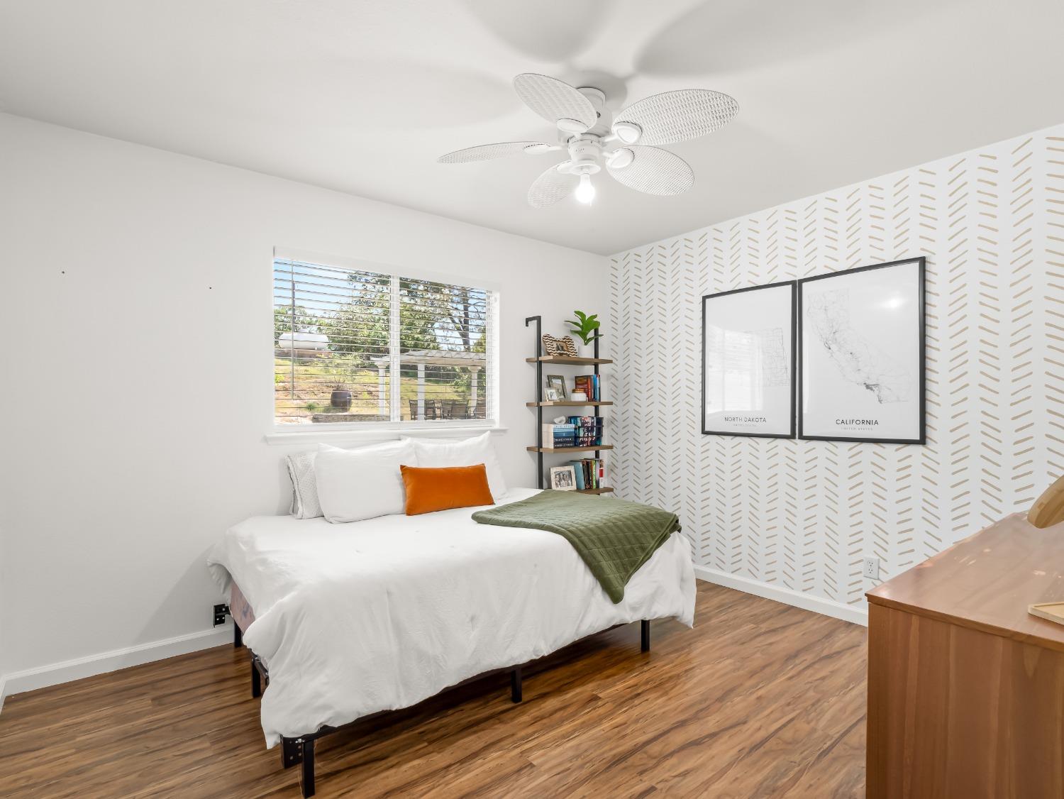 31173 Moccassin Way Coarsegold, CA 93614 - Photo 23 of 48 a bedroom with a large bed and a chandelier