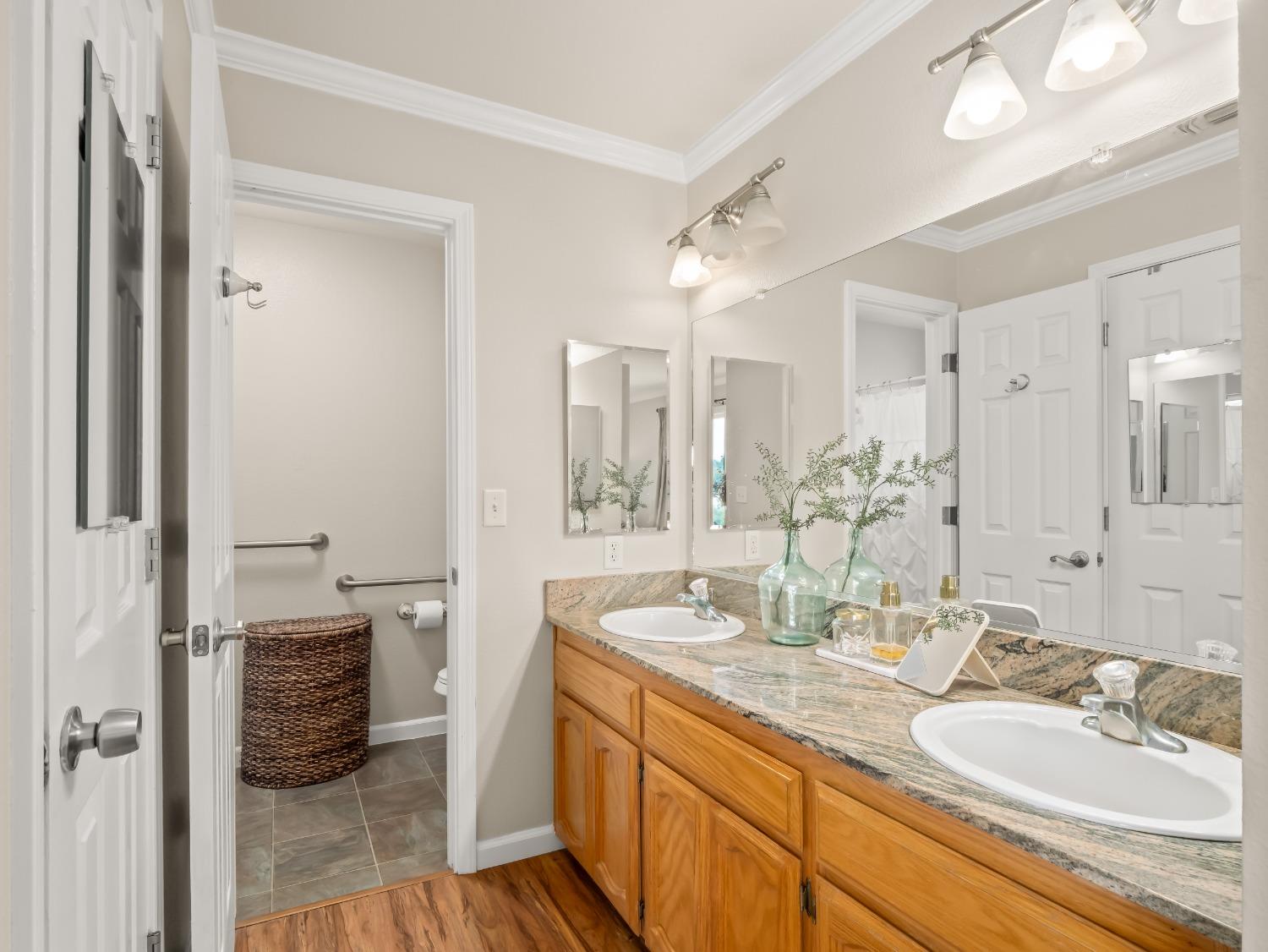 31173 Moccassin Way Coarsegold, CA 93614 - Photo 30 of 48 a bathroom with a double vanity sink and a mirror