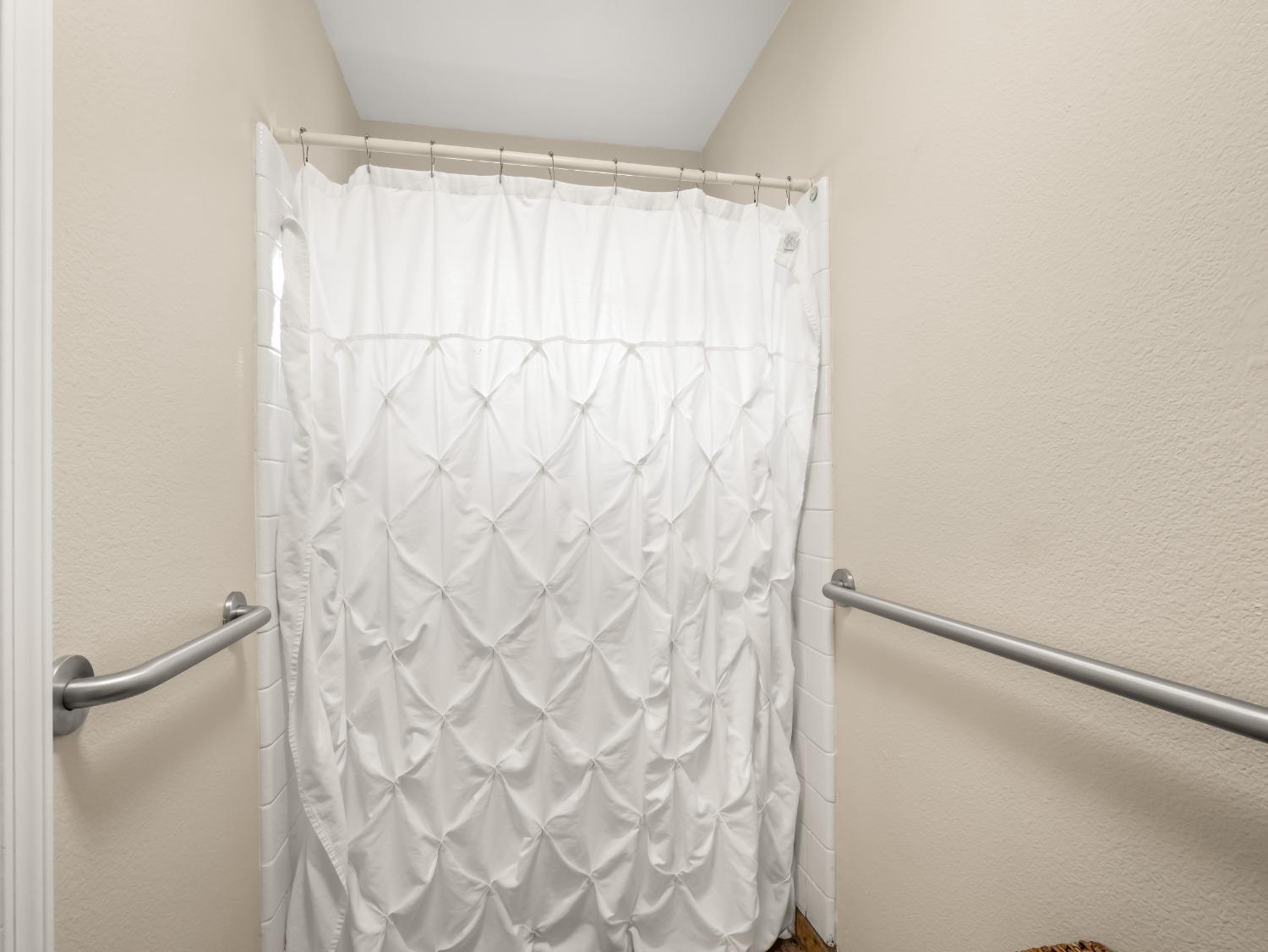 31173 Moccassin Way Coarsegold, CA 93614 - Photo 31 of 48 a bathroom with a shower curtain and a window
