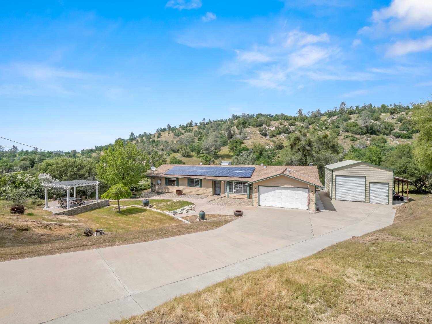 31173 Moccassin Way Coarsegold, CA 93614 - Photo 34 of 48 a view of a house with a swimming pool