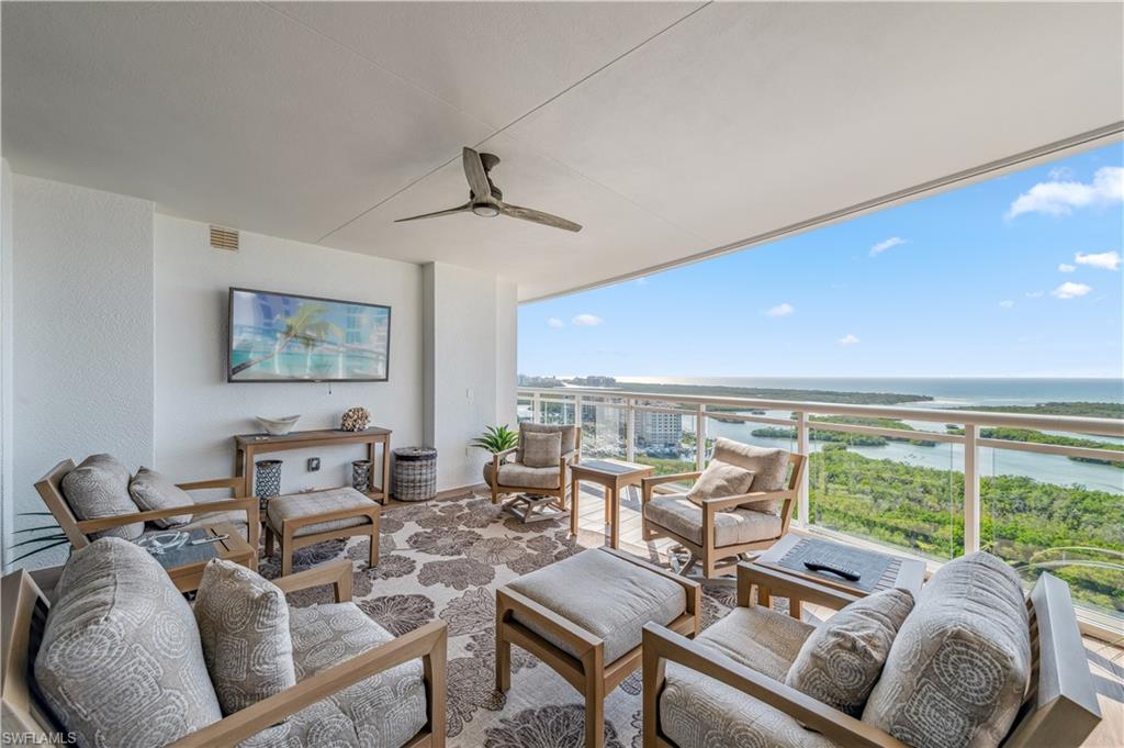 13915 Old Coast Road, Unit 2004 Naples, FL 34110 - Photo 17 of 29 a living room with furniture and large windows