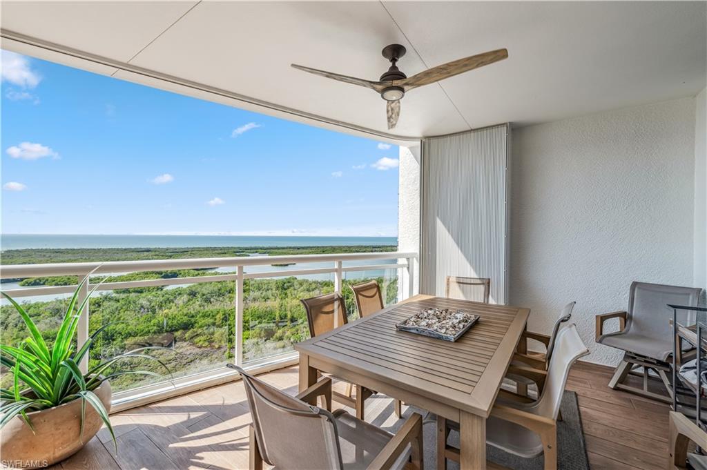 13915 Old Coast Road, Unit 2004 Naples, FL 34110 - Photo 18 of 29 a view of a dining room with furniture window and wooden floor