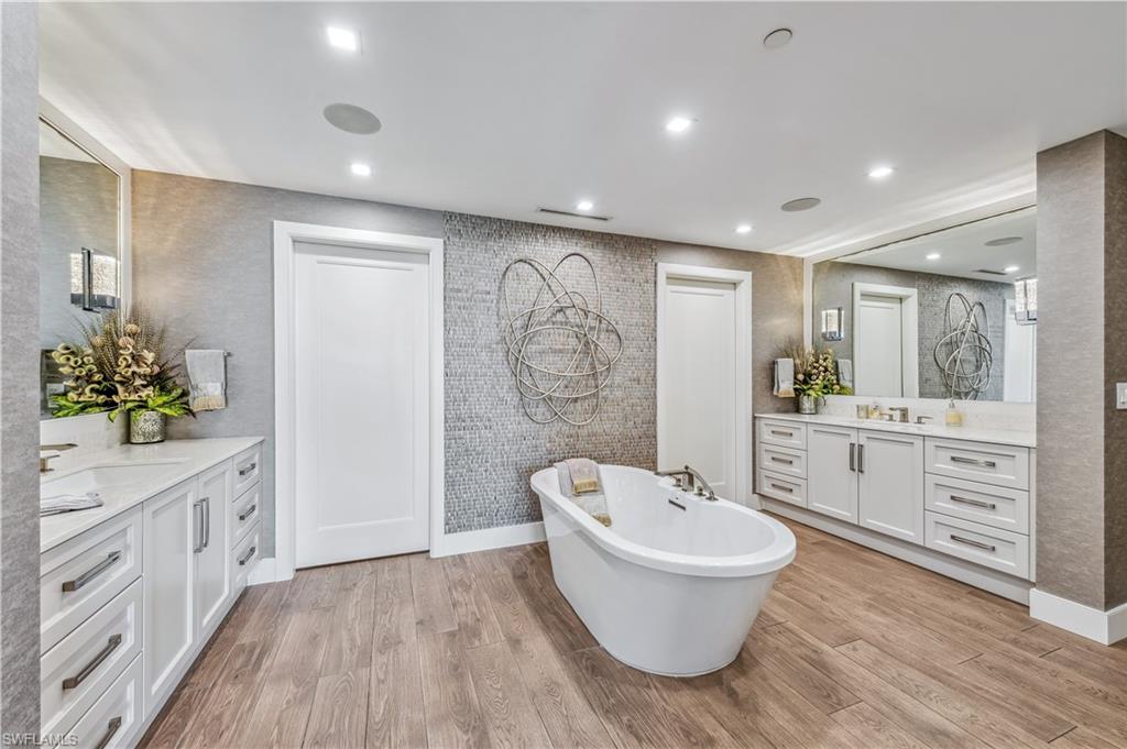 13915 Old Coast Road, Unit 2004 Naples, FL 34110 - Photo 9 of 29 a spacious bathroom with a double vanity sink a toilet a mirror and a shower