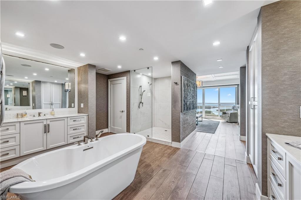 13915 Old Coast Road, Unit 2004 Naples, FL 34110 - Photo 10 of 29 a large spacious bathroom with a large tub shower sink and toilet