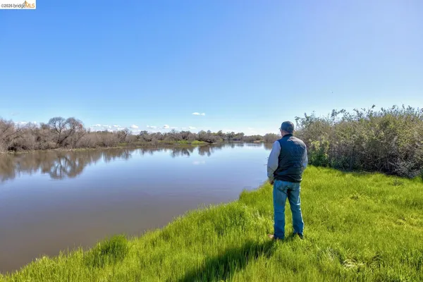 a view of a lake with houses in the background