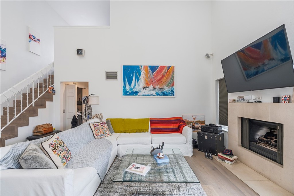 a living room with furniture fireplace and flat screen tv