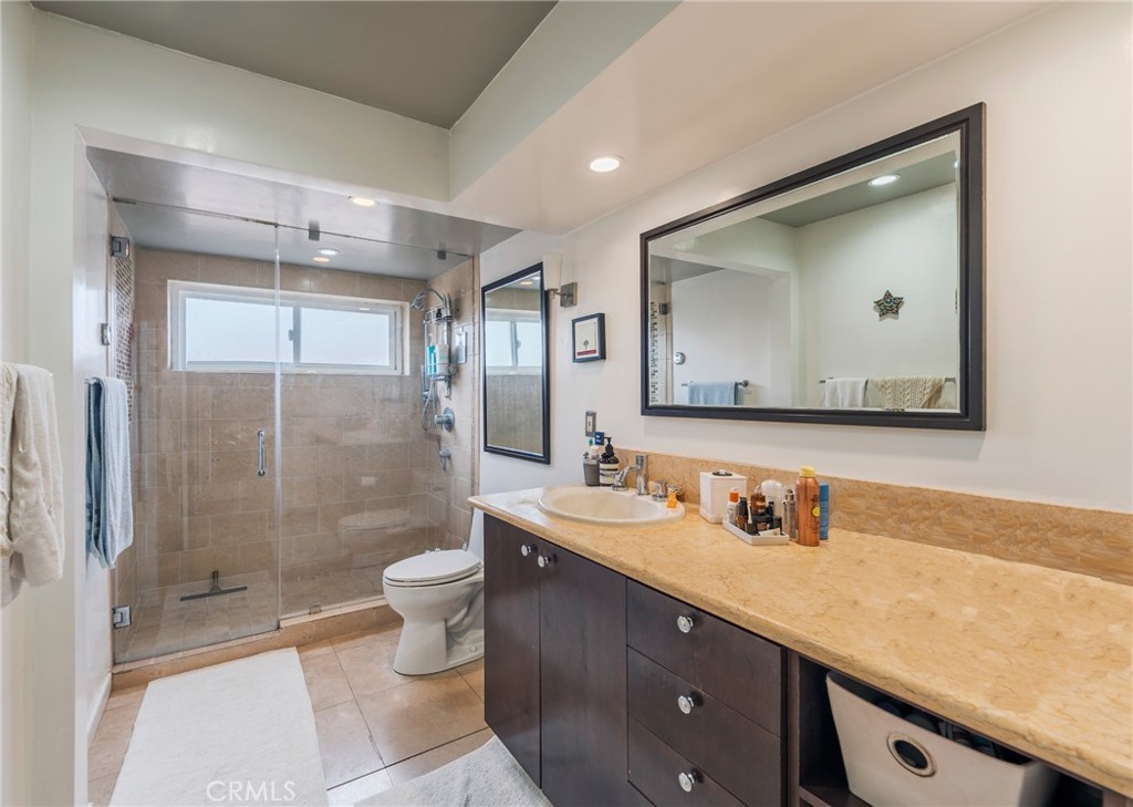 432 South Hamel Road, Unit 302 Los Angeles, CA 90048 - Photo 12 of 21 a bathroom with a double vanity sink mirror and toilet