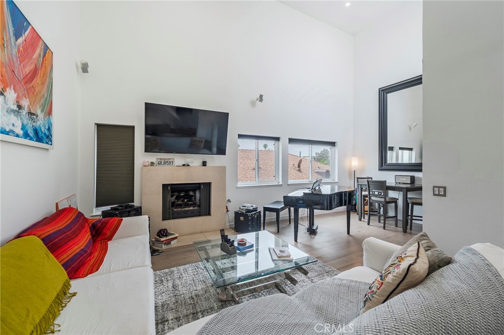 432 South Hamel Road, Unit 302 Los Angeles, CA 90048 - Photo 4 of 21 a living room with furniture a flat screen tv and a fireplace