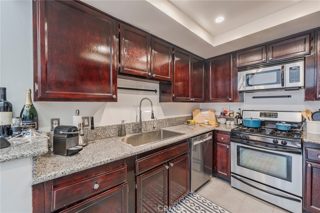 432 South Hamel Road, Unit 302 Los Angeles, CA 90048 - Photo 6 of 21 a kitchen with stainless steel appliances granite countertop a sink stove and cabinets