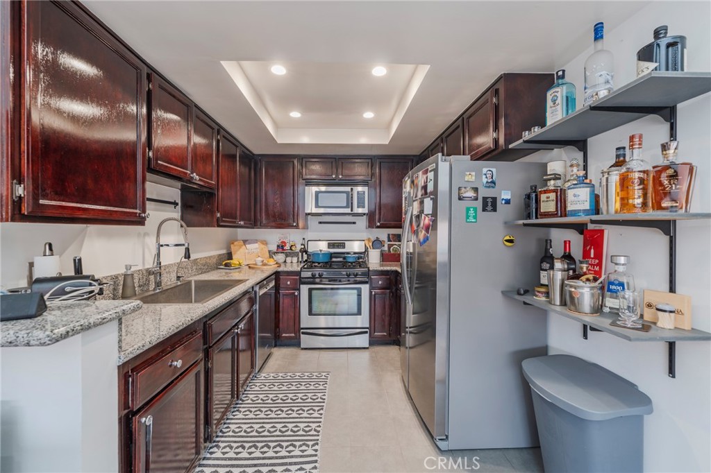 432 South Hamel Road, Unit 302 Los Angeles, CA 90048 - Photo 7 of 21 a kitchen with stainless steel appliances granite countertop a sink stove and cabinets