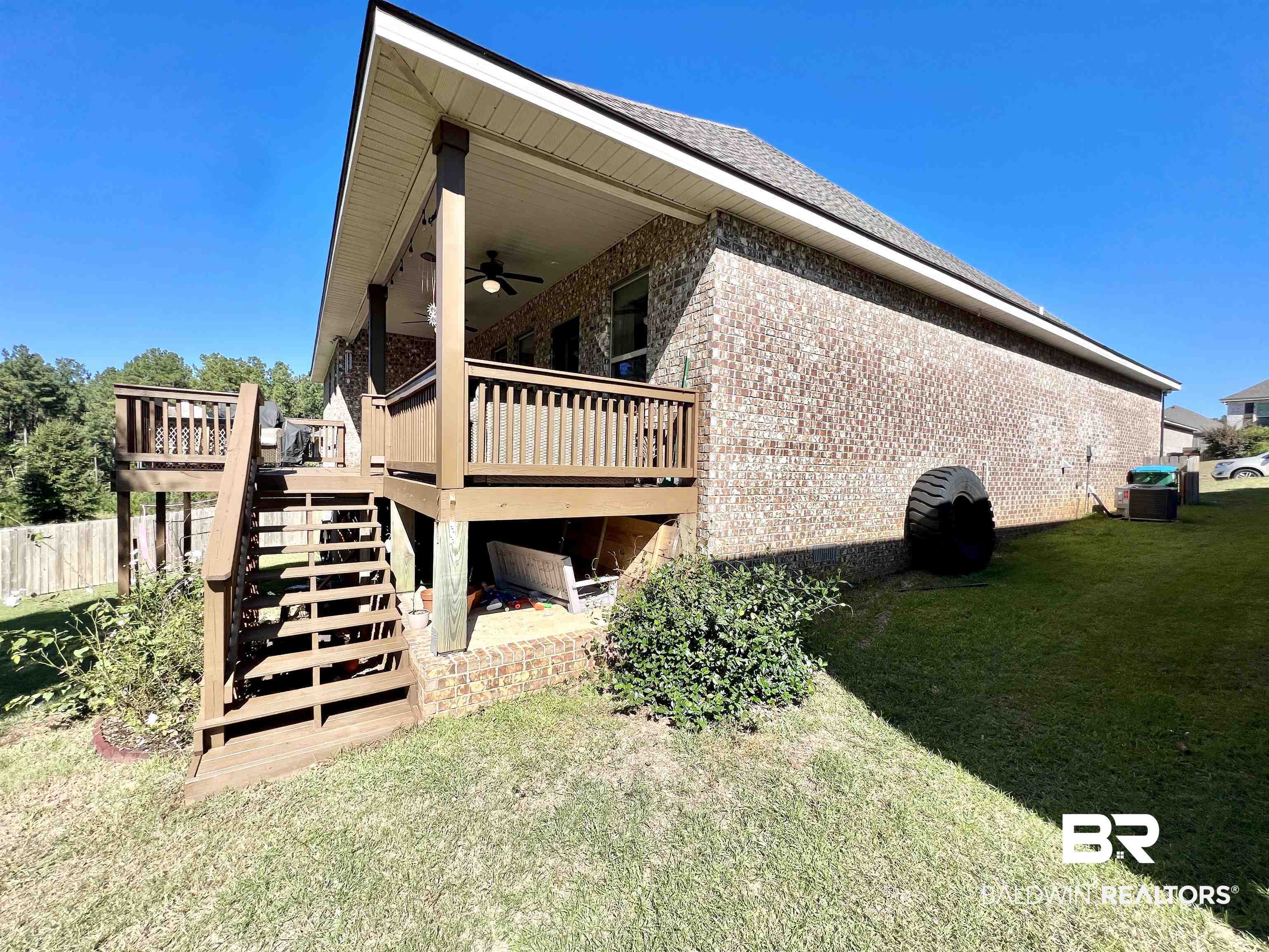 32290 Calder Court Daphne, AL 36527 - Photo 52 of 59 View of side of home with cooling unit, a deck, a lawn, and ceiling fan