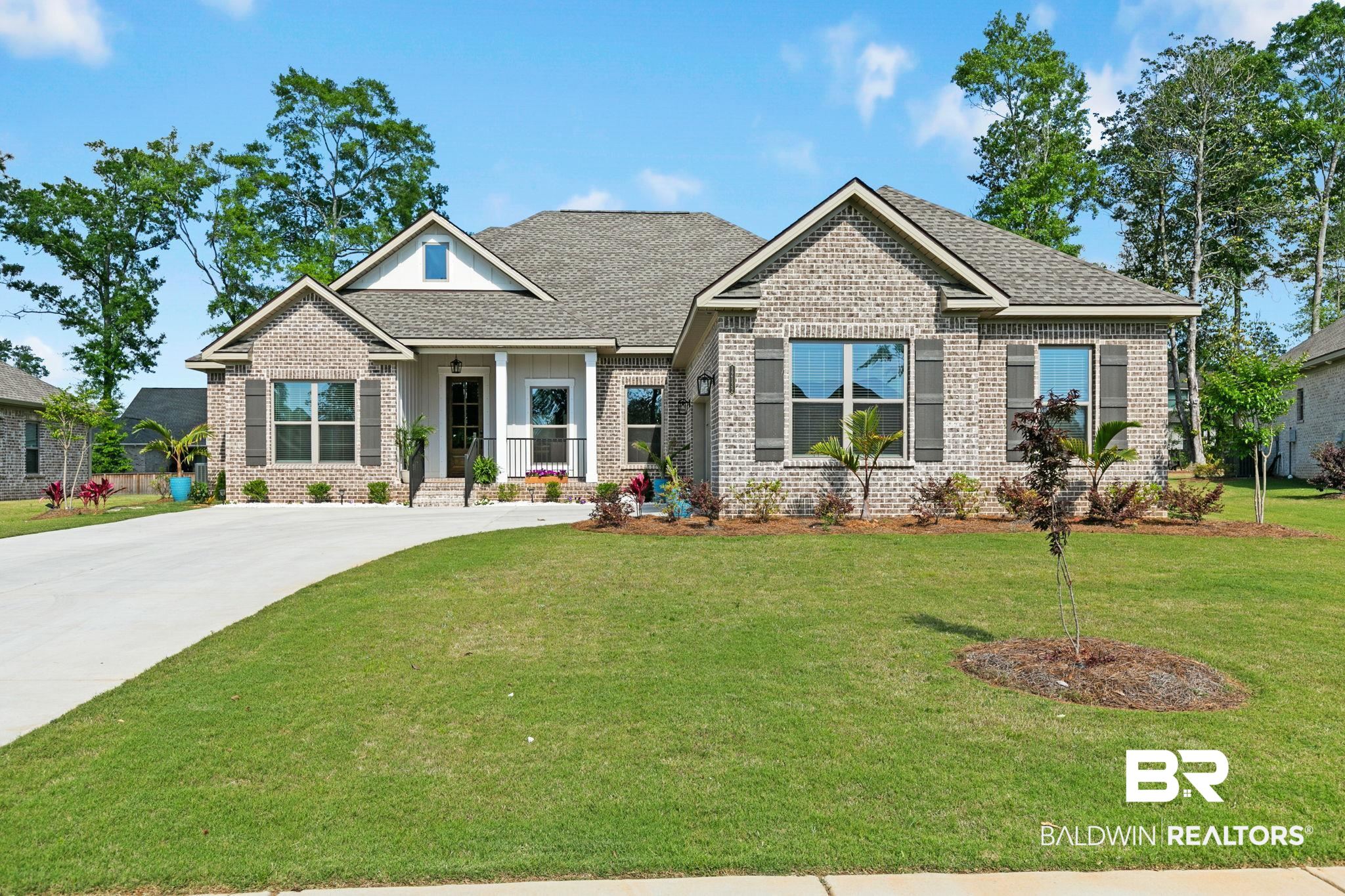 12132 Exbury Way Daphne, AL 36527 - Photo 1 of 47 Craftsman house with covered porch, a front yard, brick siding, and roof with shingles