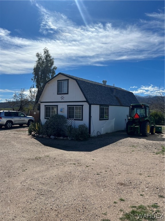 19167 Cholla Canyon Ranch Road Wikieup, AZ 85360 - Photo 1 of 97 a front view of a house with a yard