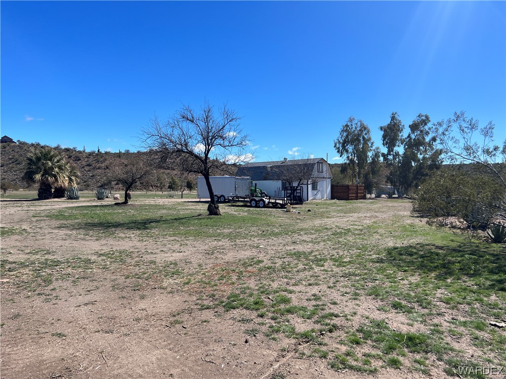 19167 Cholla Canyon Ranch Road Wikieup, AZ 85360 - Photo 17 of 97 a view of a house with a yard