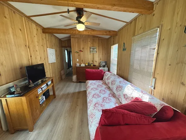 a bed sitting in a bedroom next to a wooden floor