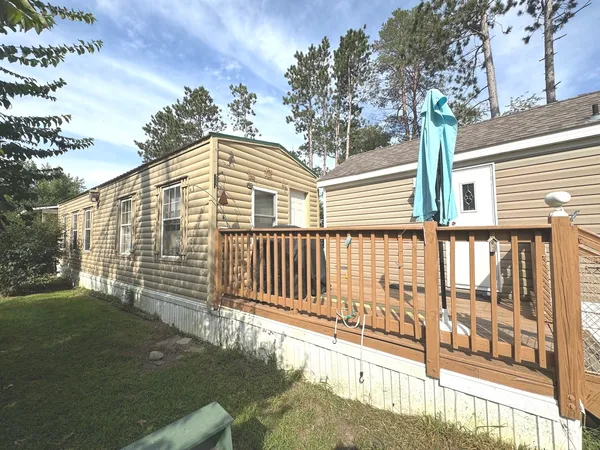 a porch with a bench in front of house