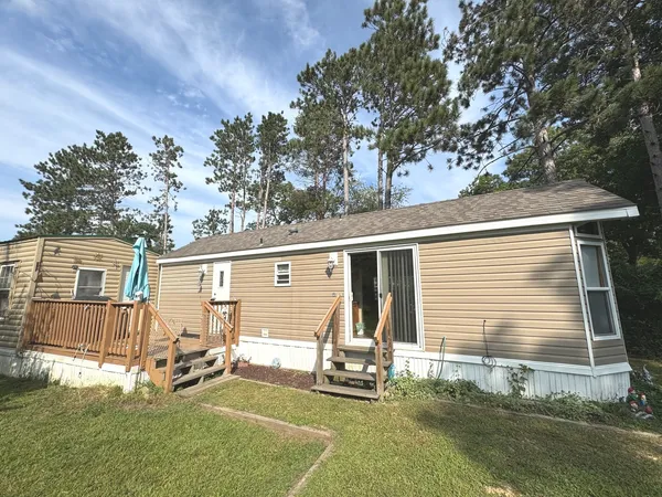 a view of a chair and table in backyard of the house