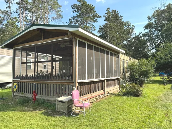 a view of a backyard with wooden fence