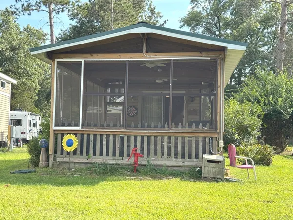 a view of backyard with garden and deck