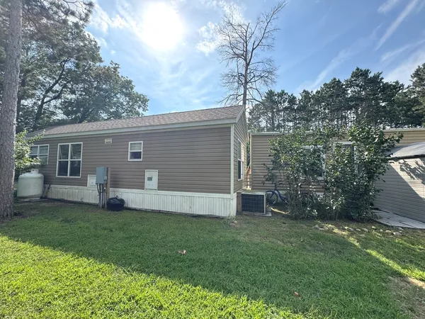 a view of backyard with deck and garden