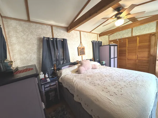 a bedroom with a bed and flat screen tv