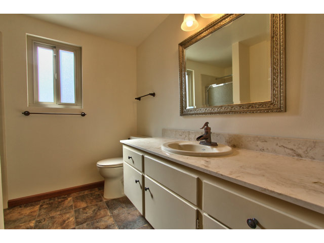 22675 Coleta Drive Salinas, CA 93908 - Photo 15 of 23 a bathroom with a granite countertop sink toilet and mirror