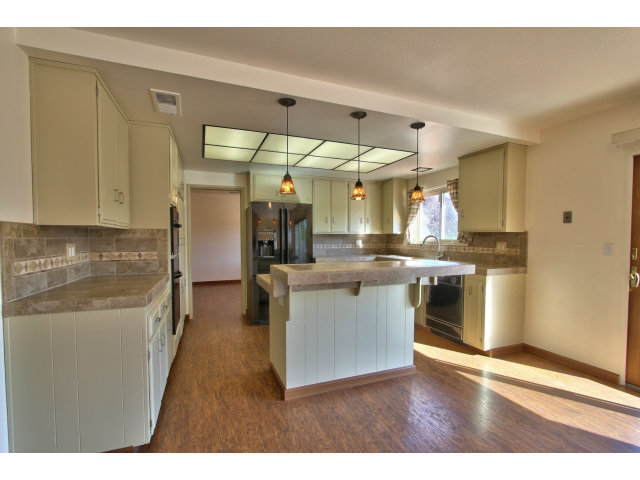 22675 Coleta Drive Salinas, CA 93908 - Photo 8 of 23 a kitchen with stainless steel appliances wooden floor and a refrigerator