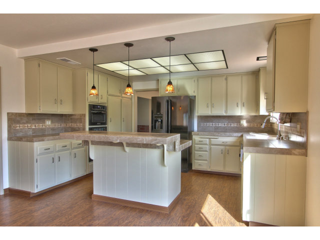 22675 Coleta Drive Salinas, CA 93908 - Photo 9 of 23 a kitchen with stainless steel appliances kitchen island granite countertop a sink and cabinets