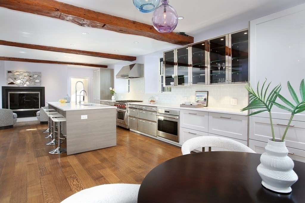 14 Walnut Street Boston, MA 02108 - Photo 14 of 42 a living room with furniture a flat screen tv and kitchen view