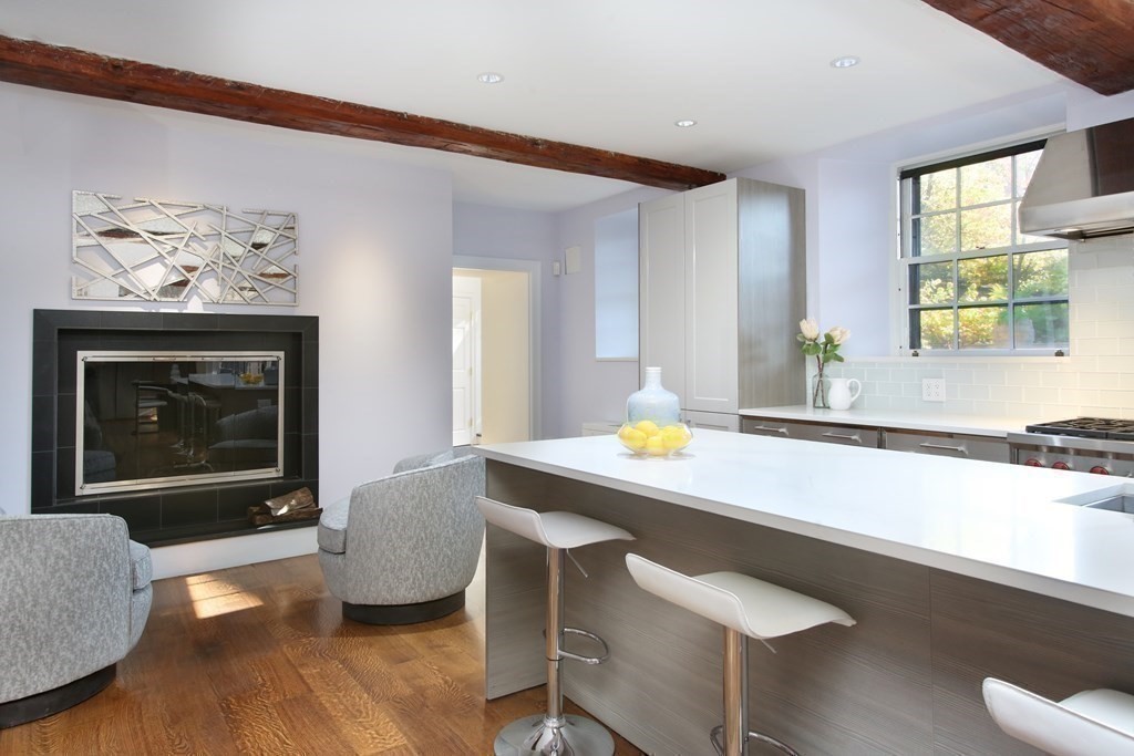 14 Walnut Street Boston, MA 02108 - Photo 18 of 42 a living room with furniture a window and a fireplace