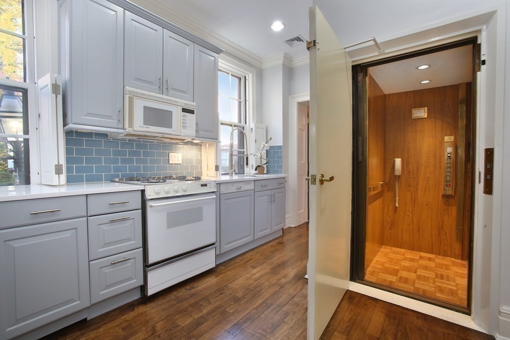 14 Walnut Street Boston, MA 02108 - Photo 22 of 42 a kitchen with white cabinets and white appliances