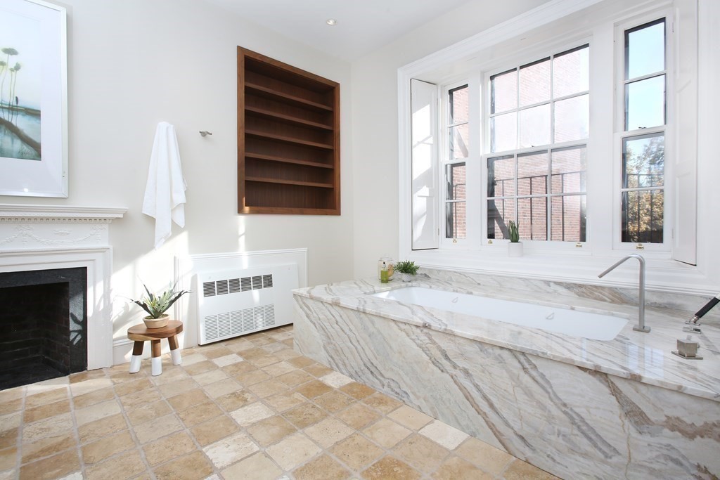 14 Walnut Street Boston, MA 02108 - Photo 27 of 42 a spacious bedroom with a bed and a fireplace