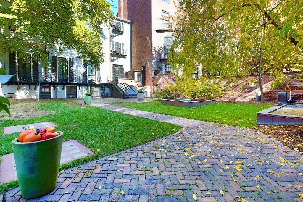 14 Walnut Street Boston, MA 02108 - Photo 9 of 42 a front view of a house with a yard and fountain