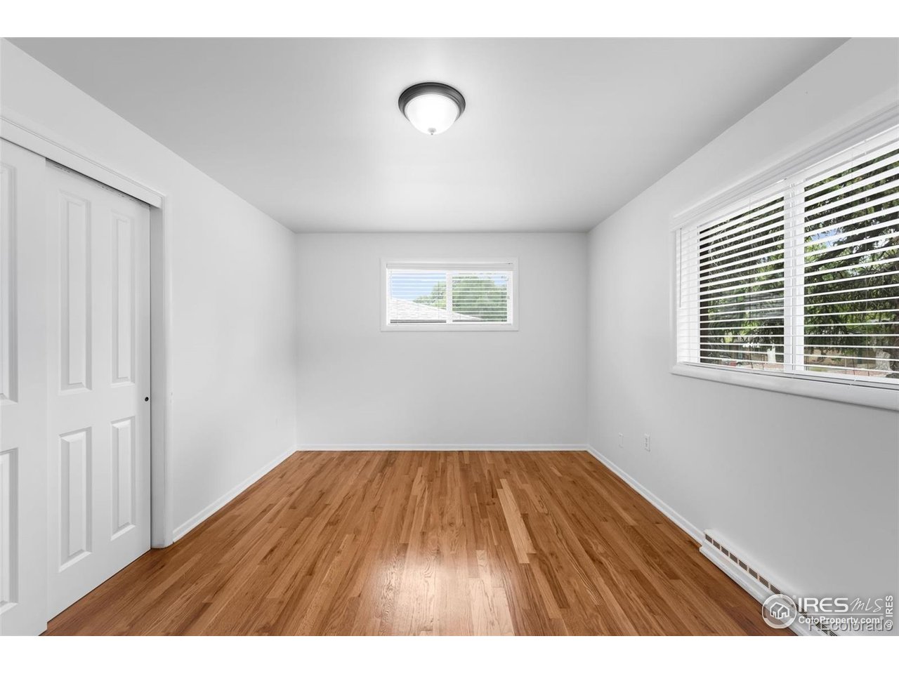 4175 South Inca Street Englewood, CO 80110 - Photo 12 of 29 a view of an empty room with wooden floor and a window