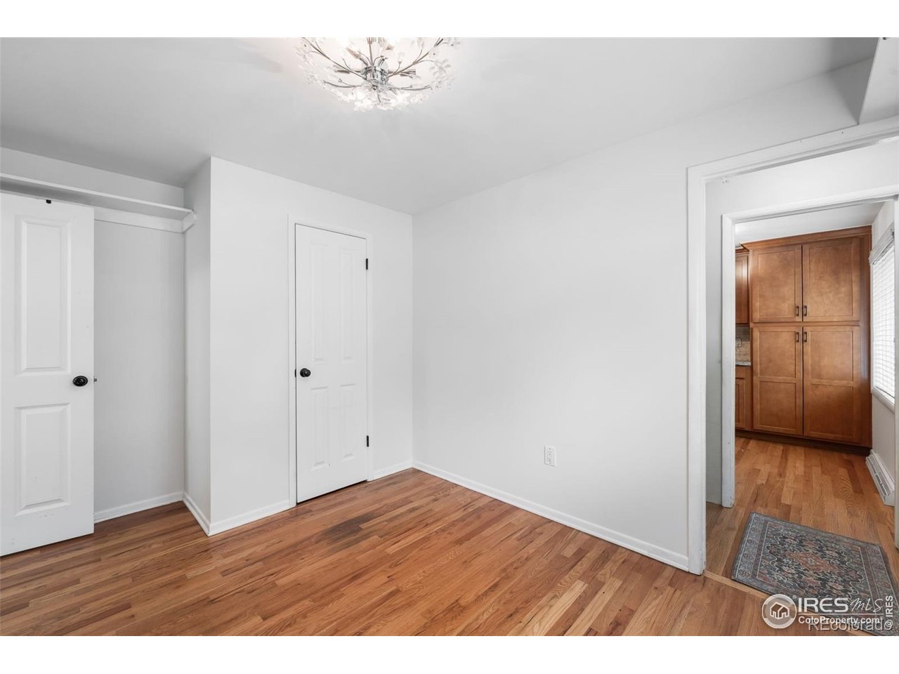 4175 South Inca Street Englewood, CO 80110 - Photo 13 of 29 a view of an empty room with wooden floor