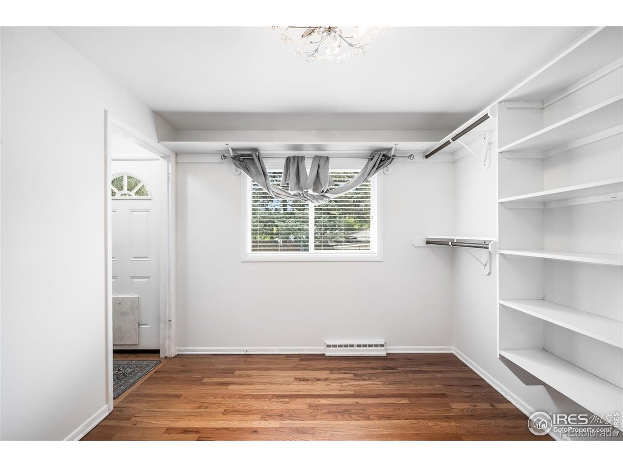 4175 South Inca Street Englewood, CO 80110 - Photo 15 of 29 a view of an empty room with window and wooden floor
